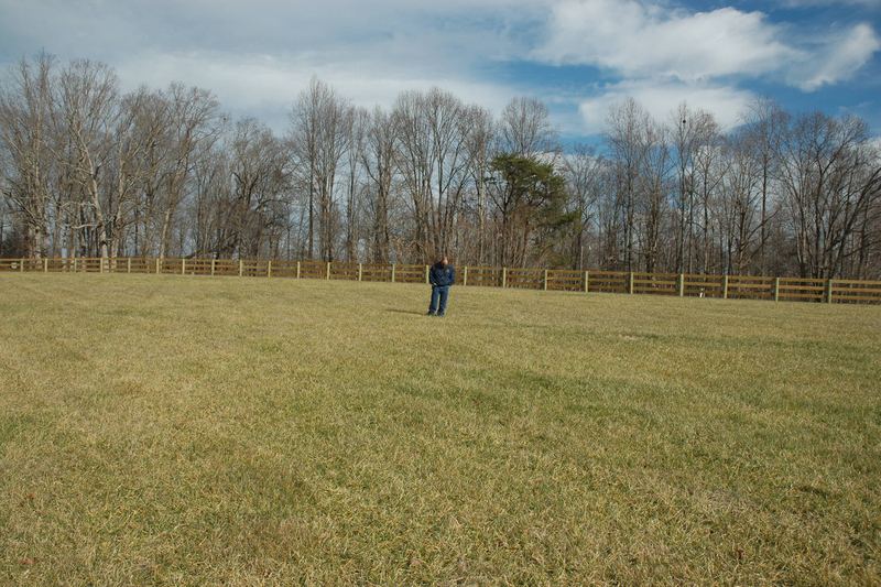 Person walking an open field during a soil and site evaluation